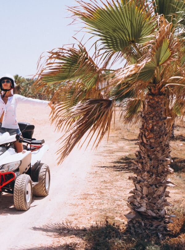 Woman travelling on quad by th ocean